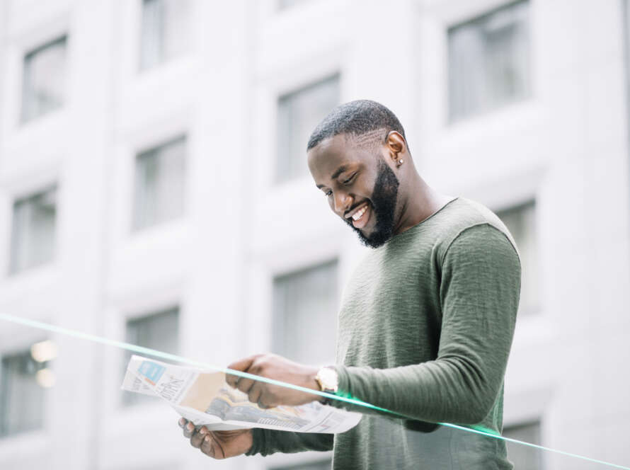 smiling-man-reading-newspaper